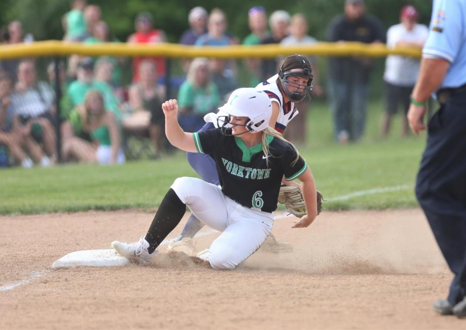 Yorktown softball freshman Abbey Booher slides into third base against Bellmont in their regional championship game at Yorktown Sports Park on Tuesday, May 31, 2022.