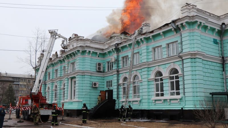 Firefighters work to extinguish a fire at a hospital in Blagoveshchensk