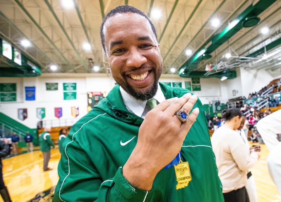 Washington head coach Steve Reynolds shows off his ring during the championship ring ceremony for the 2021-22 state championship team Tuesday, Nov. 15, 2022 at Washington High School.