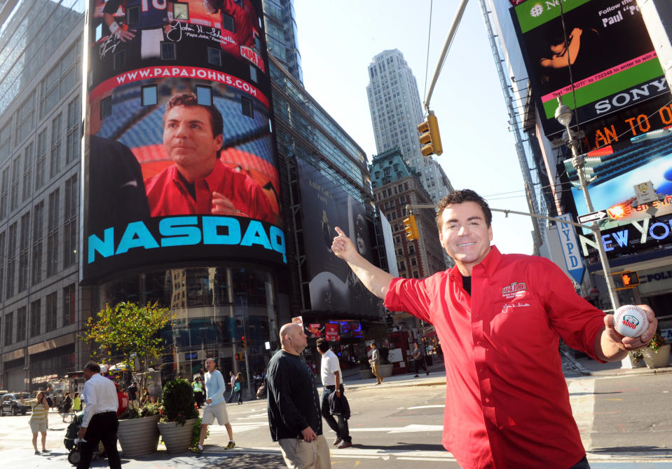 John Schnatter points to his image on the NASDAQ tower in New York, Sept. 14, 2012, celebrating the opening of the brand’s 4,000th global restaurant. (Diane Bondareff/Invision for Papa John’s International/AP Images)