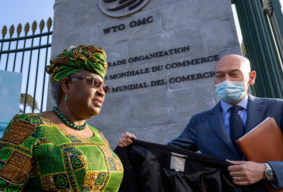 FILE - In this Monday, March 1, 2021 file photo, New Director-General of the World Trade Organisation Ngozi Okonjo-Iweala, left, walks at the entrance of the WTO, following a photo-op upon her arrival at the WTO headquarters to take office in Geneva, Switzerland. Ambassadors from World Trade Organization countries were discussing trade rules protecting the technological know-how behind COVID-19 vaccines. The WTO’s General Council's agenda for a two-day meeting starting Wednesday, May 5, 2021 includes a waiver on intellectual property protections for vaccines. (Fabrice Coffrini/Pool/Keystone via AP, FIle)