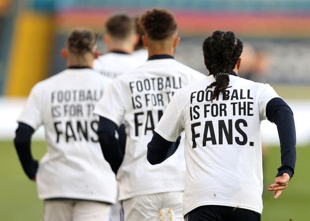 Leeds United players wearing ‘Football Is For The Fans’ shirts during the warm up to their match against Liverpool 