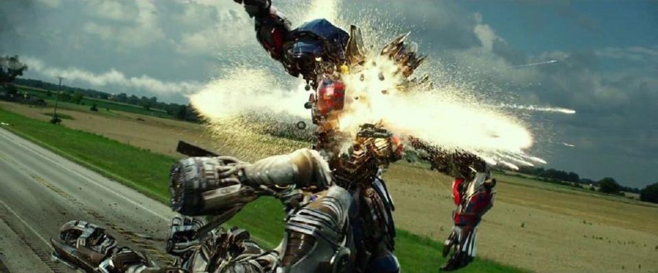 a struck optimus prime sparks with injury in a scene from transformers age of extinction