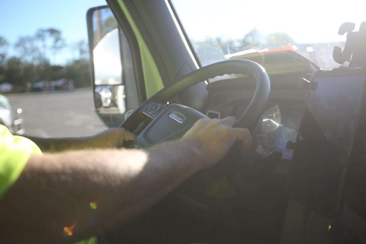 Daniel Withers steers his 40,000 pound truck to make a stop in Tuscaloosa, Alabama, Dec. 18, 2023.