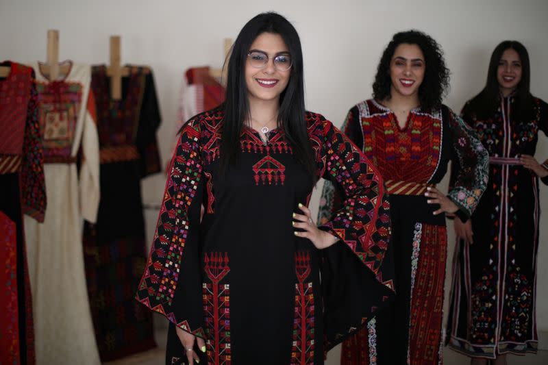 Models present traditional Palestinian dresses at Al Hanouneh society for popular culture in Amman