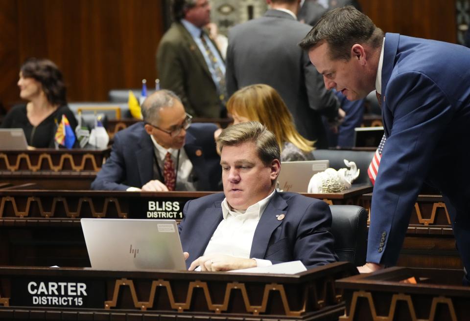 Rep. Justin Wilmeth (R) and Rep. Neal Carter speak during a session at the Arizona state Capitol in Phoenix on March 21, 2023.