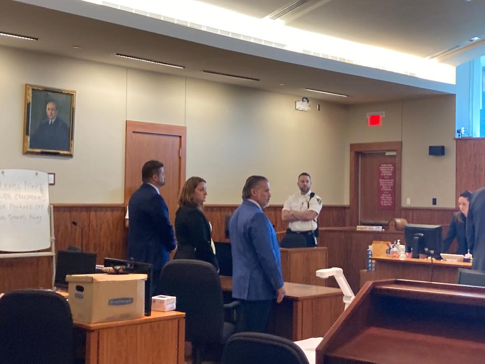 Former Fall River police officer Michael Pessoa, far left, listens as the verdict is read in his excessive force case. The jury found the 19-year city police officer guilty on four counts in the case. With him is his attorney Frank Camera and co-counsel Kathryn Blythe.