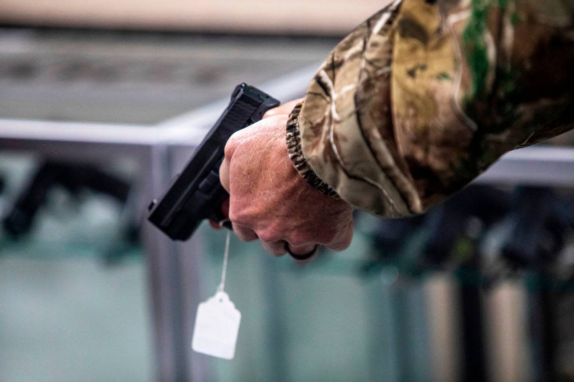 A customers checks out a handgun at Fuquay Gun & Gold in Fuquay-Varina Monday, Jan. 25, 2020. Gun sales have soared across the Triangle in the wake of recent protests and a change in the presidential administration.