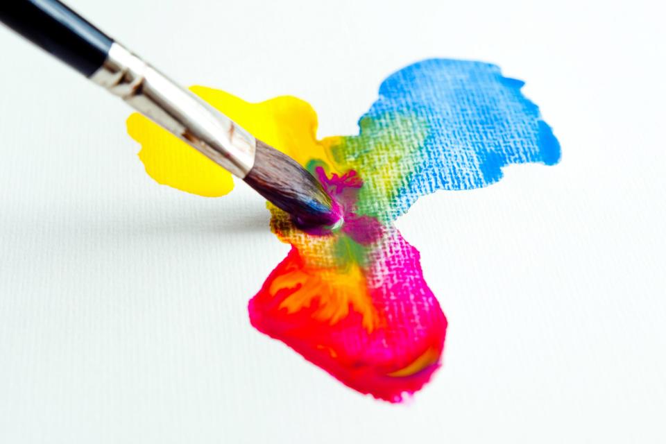 A paintbrush mixing watercolors