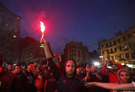 A protester holds a flare during a demonstration against a new law restricting demonstrations, in downtown Cairo November 27, 2013. REUTERS/Mohamed Abd El Ghany