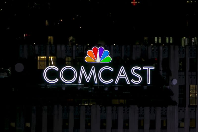 The NBC and Comcast logo are displayed on top of 30 Rockefeller Plaza, formerly known as the GE building, in midtown Manhattan in New York