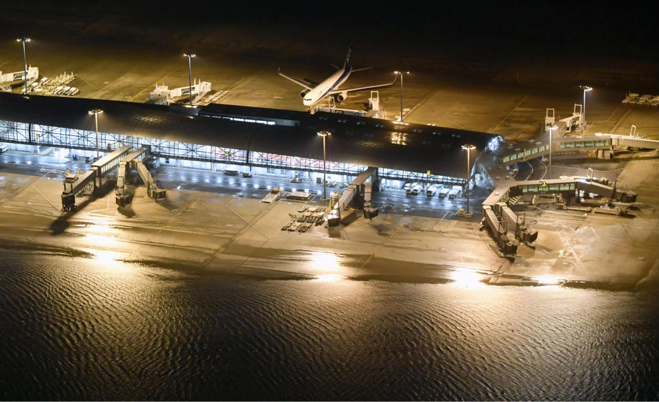 <em>An aerial view shows a flooded runway at Kansai airport, which is built on a man-made island in a bay (Reuters)</em>