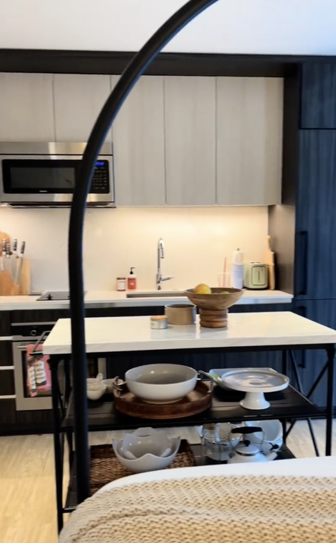 Modern kitchen interior with a variety of dishes and cookware on the counter