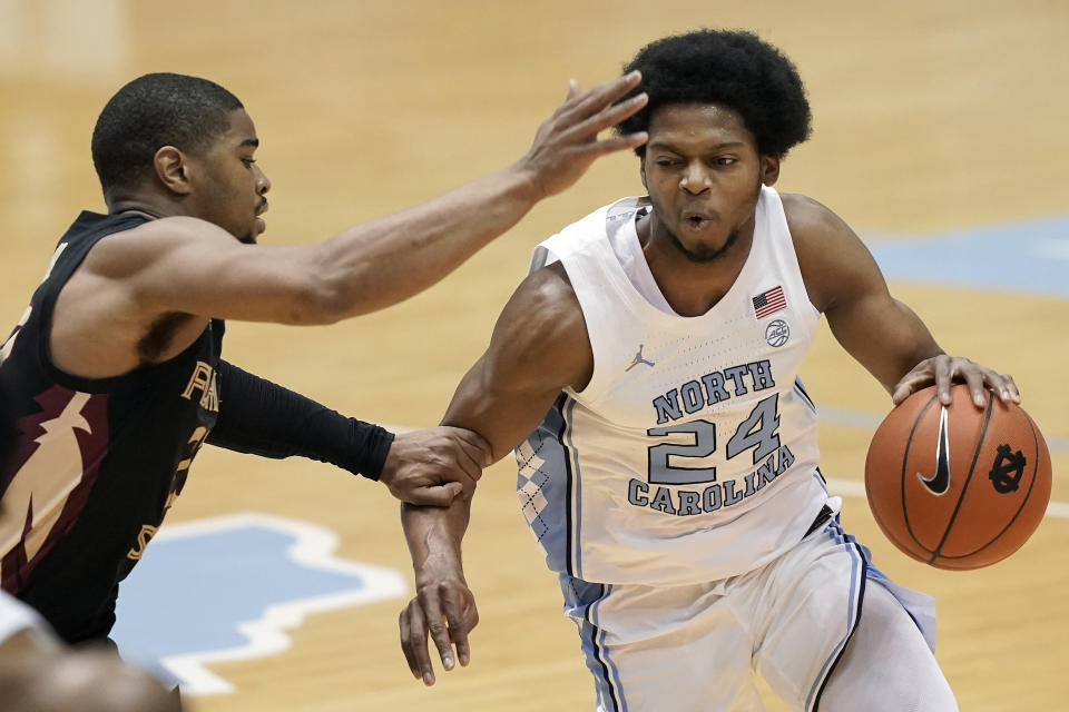 Florida State guard M.J. Walker, left, guards North Carolina guard Kerwin Walton (24) during the first half of an NCAA college basketball game in Chapel Hill, N.C., Saturday, Feb. 27, 2021. (AP Photo/Gerry Broome)