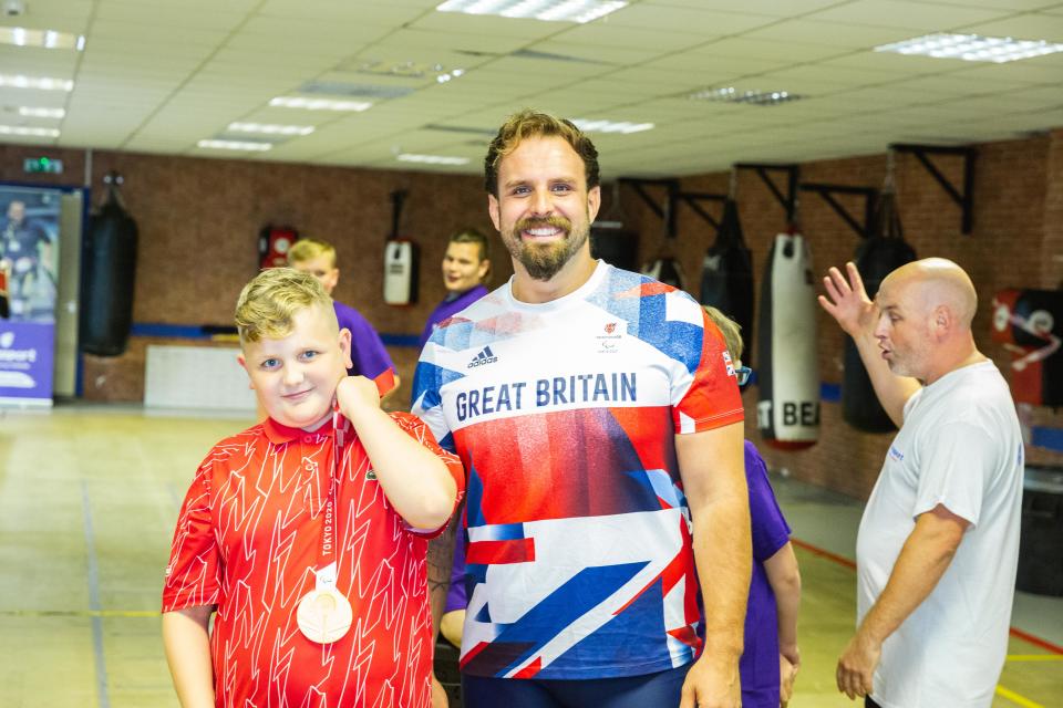 Three-time Paralympic champion Aled Davies with his Paralympic medal at an inclusive session for all generations at Pembroke Dock Amateur Boxing Club.