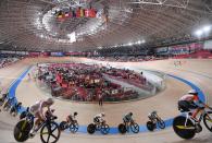 <p>Cyclists compete in the women's track cycling omnium scratch race during the Tokyo 2020 Olympic Games at Izu Velodrome in Izu, Japan, on August 8, 2021. (Photo by Greg Baker / AFP)</p> 