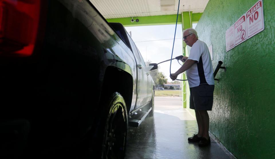 Phil Harrison, of Landenberg, PA, washes his truck Thursday morning at Coral Reef Car Wash in Cape Coral. New owner John McCarthy added an Istobal-branded car wash that can accommodate vehicles of up to nine feet, six inches tall, including extended-height vans. He purchased the rundown wash in April, spent three months renovating it and then later added the new machine.