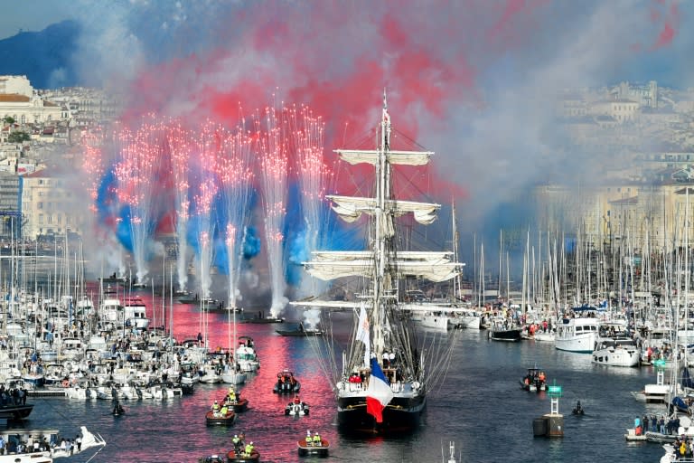 Fireworks go off as the 19th century Belem sailing ship carries the Olympic flame into Marseille's Old Port (Sylvain THOMAS)