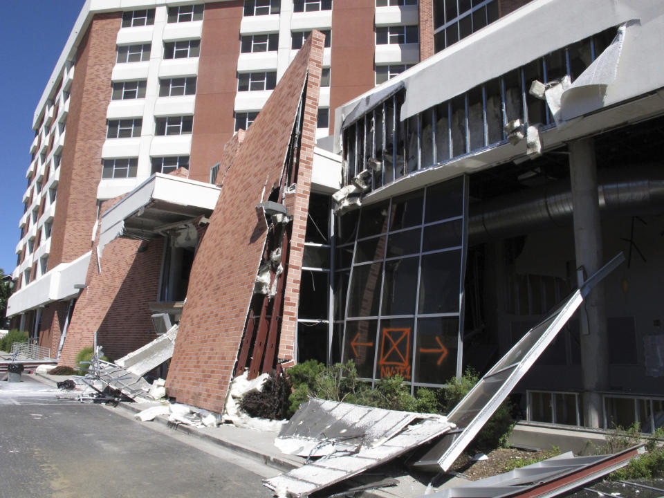 Structural engineers with experience responding to earthquakes and natural disasters are helping experts at the University of Nevada, Reno with efforts to rebuild this dormitory, Thursday, July 11, 2019, in Reno, Nev., where a natural gas explosion blew out walls and windows last week. School officials gave members of the media their first up-close look at the exterior and interior damage on Thursday. Only eight people suffered minor injuries in the July 5 blast. (AP Photo/Scott Sonner)