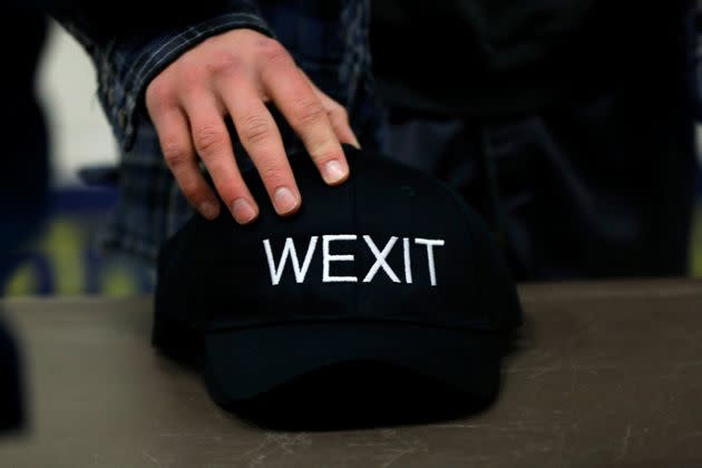 A supporter holds his Wexit hat while attending a rally in Calgary on Nov. 16, 2019. 