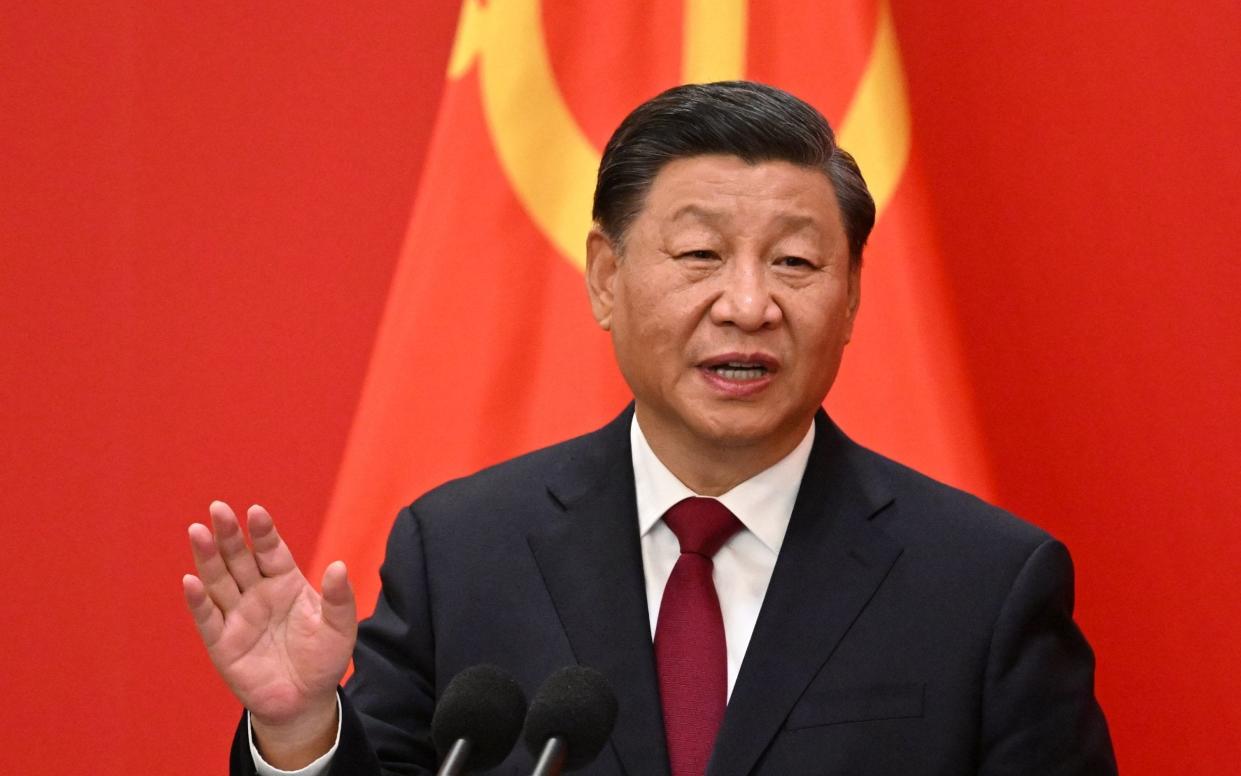 China's President Xi Jinping speaks during the introduction of members of the Chinese Communist Party's new Politburo Standing Committee - NOEL CELIS/AFP