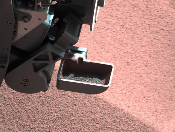 A sample of Mars dirt is shown in the scoop instrument of NASA's Curiosity Mars rover. The rover began using its scoop in October 2012, and this photo was taken by Curiosity's right Mast Camera (Mastcam-100) on Oct. 10, 2012, the 64th sol, or M