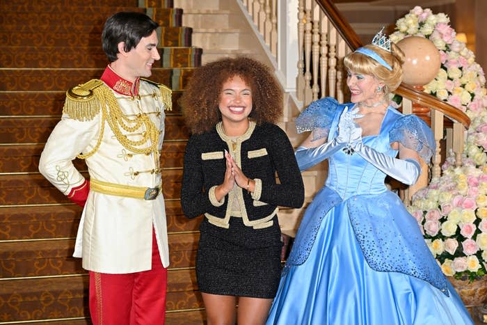A woman with Cinderella and Prince Charming at Disney World