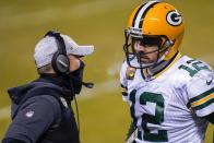 Green Bay Packers head coach Matt LaFleur talks to Aaron Rodgers during the second half of an NFL football game against the Chicago Bears Sunday, Jan. 3, 2021, in Chicago. (AP Photo/Charles Rex Arbogast)