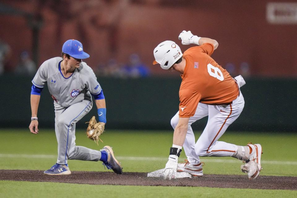 Texas outfielder Will Gasparin, right, arrives safely at second base during Tuesday night's 20-3 win over Houston Christian at UFCU Disch-Falk Field. The Longhorns collected 24 hits, which was only one hit shy of tying the school record.