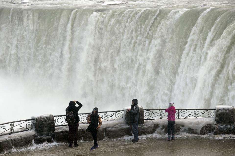 Visitors take pictures overlooking Niagara Falls