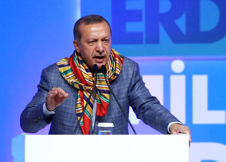 Turkish Prime Minister and presidential candidate Recep Tayyip Erdogan gestures he delivers a speech during a meeting of his ruling Justice and Development Party in Ankara on August 6, 2014