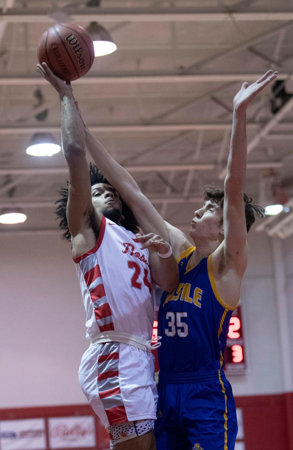 Bosse's Chris Glover II (24) shoots over Castle's Ayden McAtee (35) during their game at Bosse High School Thursday night, Feb. 2, 2023.