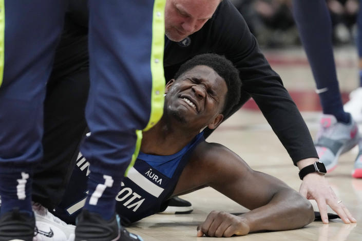 Minnesota Timberwolves guard Anthony Edwards grimaces after apparent an injury during the first half of the team's NBA basketball game against the Chicago Bulls in Chicago, Friday, March 17, 2023. (AP Photo/Nam Y. Huh)