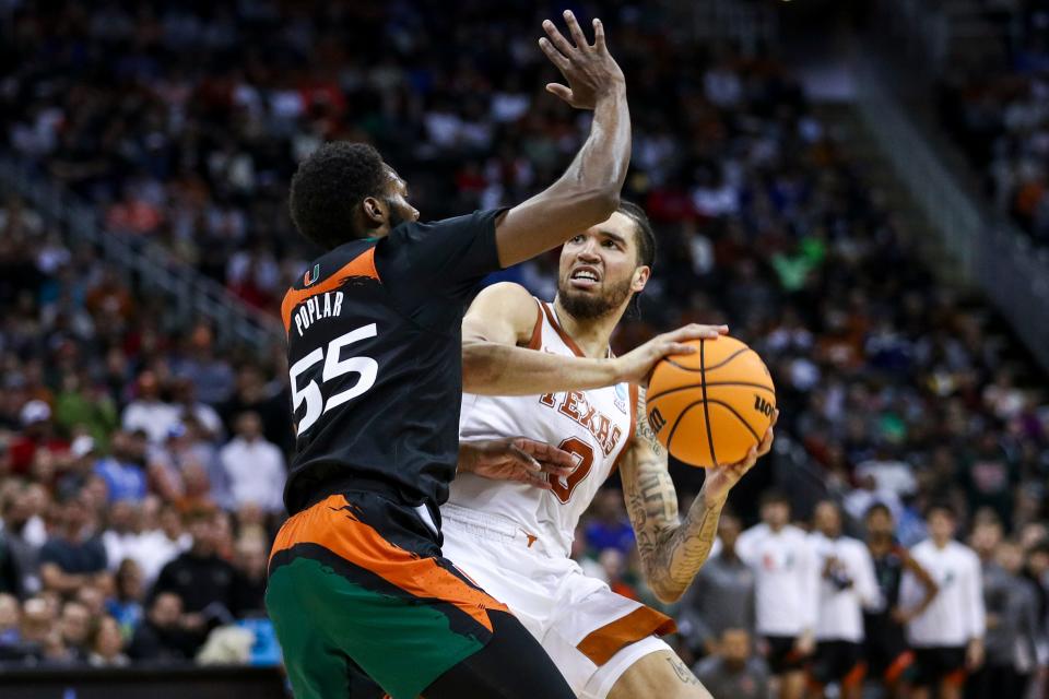 Mar 26, 2023; Kansas City, MO, USA;  Texas Longhorns forward Timmy Allen (0) controls the ball against Miami Hurricanes guard Wooga Poplar (55) in the second half at the T-Mobile Center.