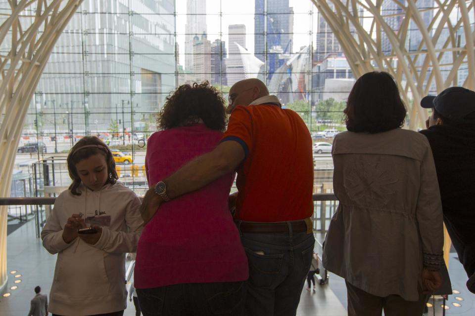 People look at the 9/11 Memorial site during memorial observances on the 13th anniversary of the 9/11 attacks at the site of the World Trade Center, in New York September 11, 2014. Politicians, dignitaries and victims' relatives were gathering in New York, Washington and Pennsylvania on Thursday to commemorate the nearly 3,000 people killed in al Qaeda's attack on the United States 13 years ago on Sept. 11. (REUTERS/Brendan McDermid)