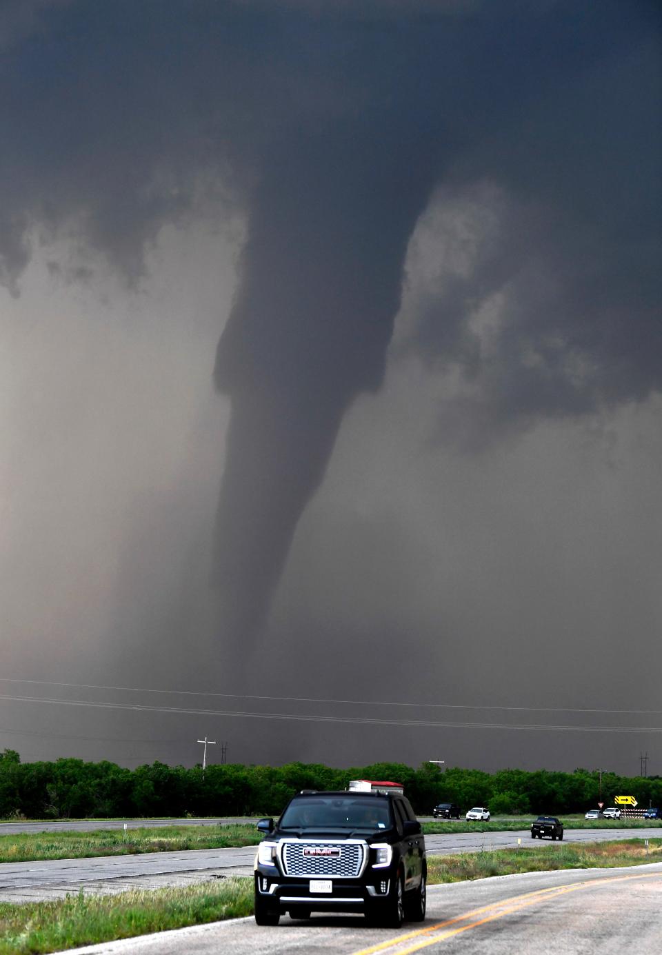 An EF3 tornado spins west of Hawley as cars pass on U.S. 277 Thursday. The twister destroyed several homes and buildings, injuring four people.