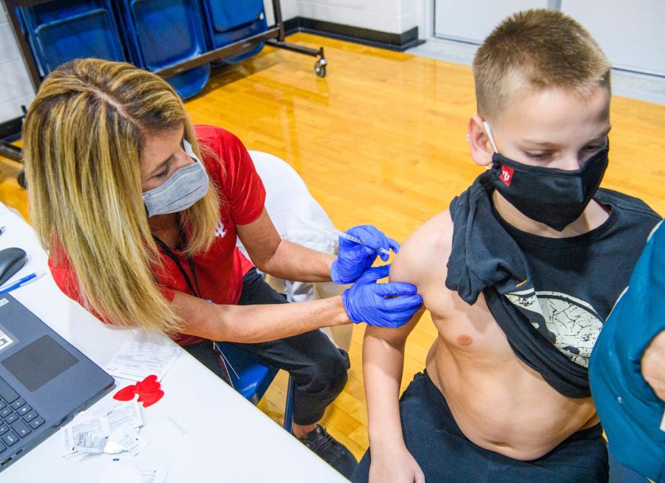 Nick Bikoff gets a COVID-19 vaccine shot from Sara Wisen, a registered nurse, at the Super Shot COVID-19 Vaccine Clinic Nov. 18, 2021,in partnership with the Health Department and IU Health at Edgewood Primary School.