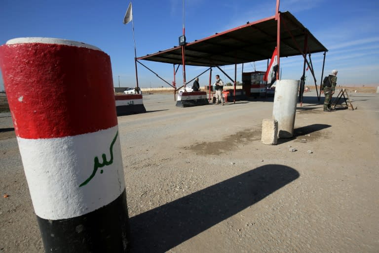 Hashed al-Shaabi fighters man a checkpoint in Bartalla east of Mosul on January 10, 2018