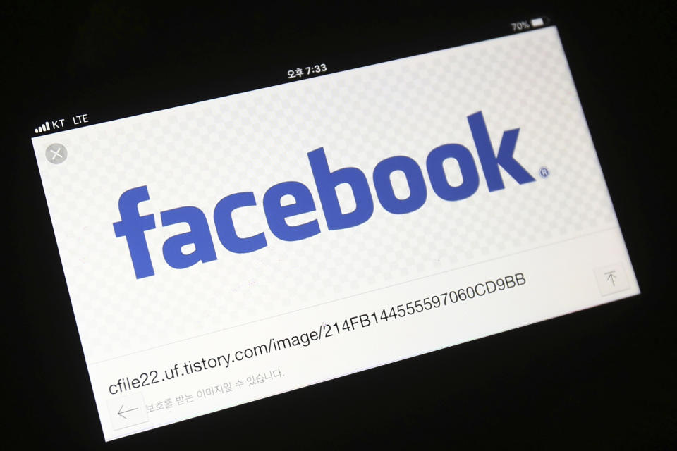 FILE - In this March 21, 2018, file photo, the Facebook logo is seen on a smartphone in Ilsan, South Korea. Thailand’s Prime Minister Prayuth Chan-ocha says he has assigned the Royal Thai Army to investigate after Facebook Inc. removed 185 accounts and groups allegedly engaged in an information-influencing operation in Thailand run by the military. (AP Photo/Ahn Young-joon)