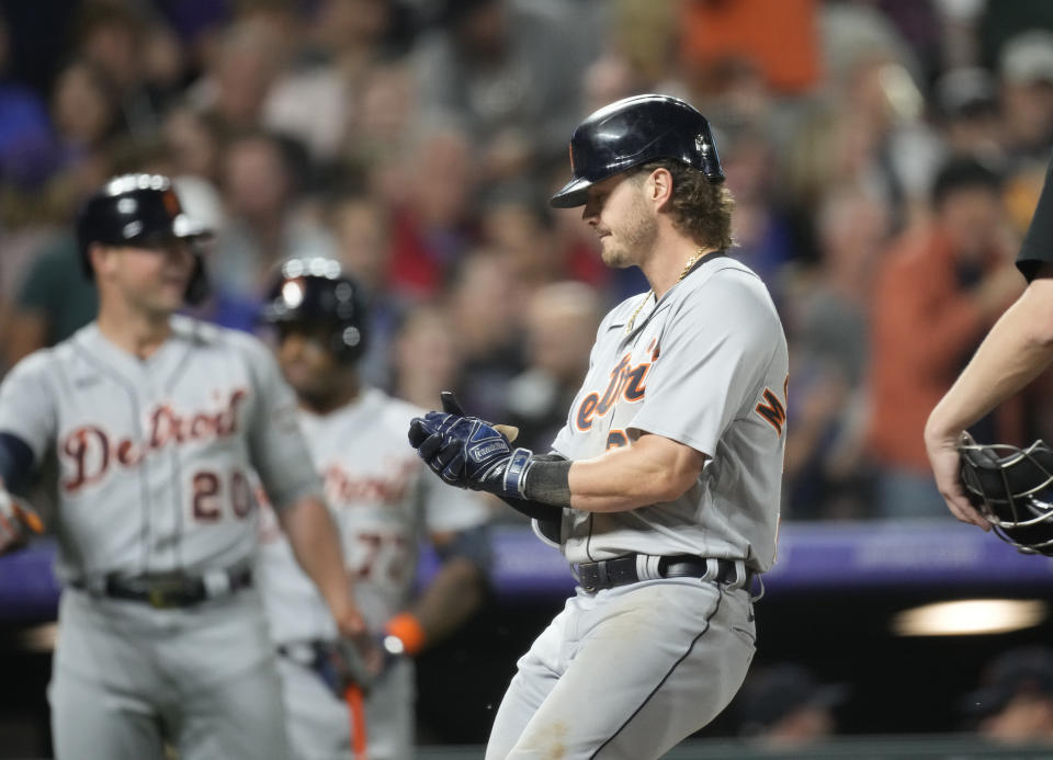Detroit Tigers' Zach McKinstry claps his hands as he crosses home plate on his three-run home run off Colorado Rockies relief pitcher Pierce Johnson during the 10th inning of a baseball game Saturday, July 1, 2023, in Denver. (AP Photo/David Zalubowski)