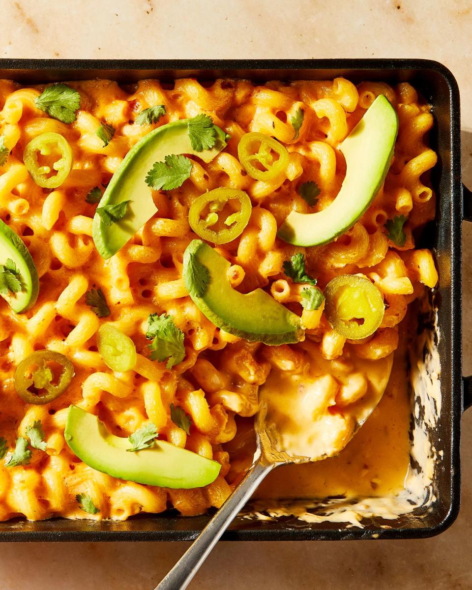 mac and cheese topped with sliced avocado and jalapenos