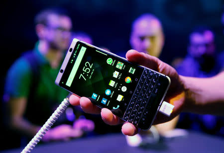 A man holds the new BlackBerry Key One during his presentation event before the Mobile World Congress in Barcelona, Spain February 25, 2017. REUTERS/Albert Gea