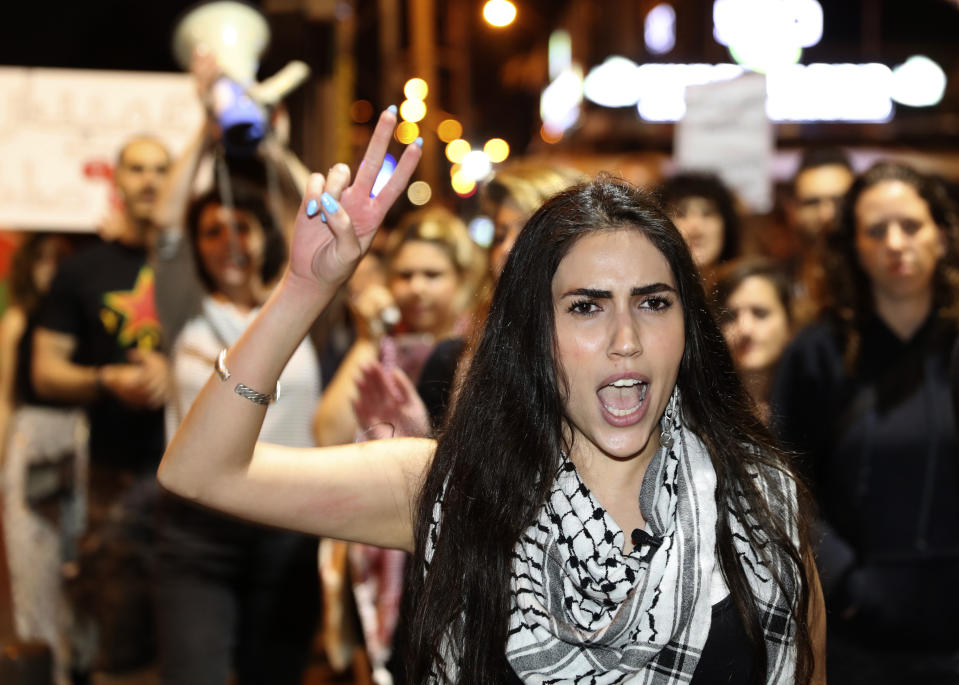 An Arab woman shouts slogans against Jewish nationalist religious groups that are buying up property in the Arab neighborhood of Jaffa, in Tel Aviv, Israel, Saturday, April 24, 2021. Historic Jaffa's rapid gentrification in recent years is coming at the expense of its mostly Arab lower class. With housing prices out of reach, discontent over the city’s rapid transformation into a bastion for Israel’s ultra-wealthy is reaching a boiling point. (AP Photo/Ariel Schalit)