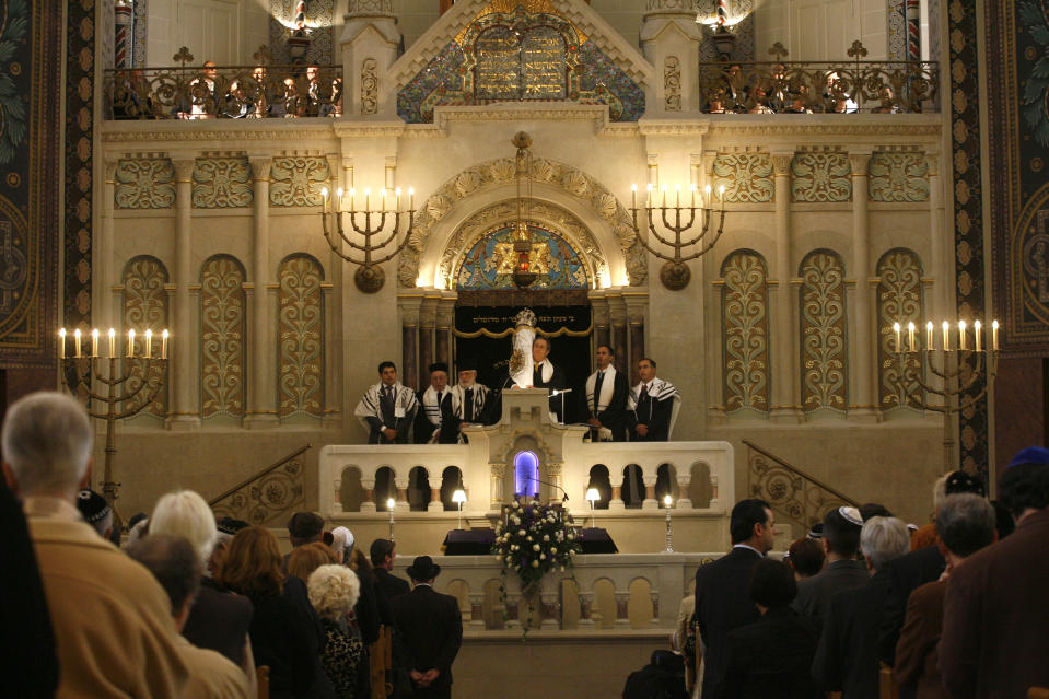 FILE - In this Aug. 31, 2007 file photo rabbis carry the Torah scrolls in a solemn procession during the reopening after renovation of Germany's biggest synagogue at the Rykestrasse in Berlin, Germany. The epicenter of the Holocaust, the city where Hitler signed the death warrants of 6 million Jews, seems an unlikely candidate for the world’s fastest growing Jewish community. But despite this stigma of Nazism, Berlin’s dynamic, prosperous present and its rich, pre-World War II Jewish past initially attracted an influx from the former Soviet Union and has continued with the arrival of thousands of Israelis and smaller numbers of often young immigrants from Australia, France, the United States and elsewhere. (AP Photo/Markus Schreiber,File)
