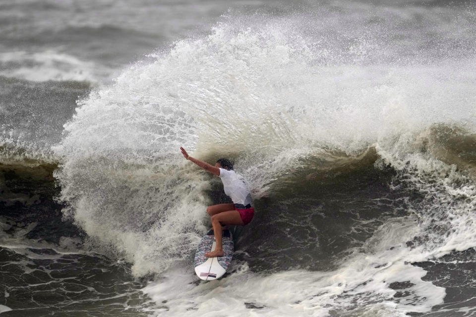 Carissa Moore, of the United States, preforms on the wave during the gold medal heat in the women's surfing competition at the 2020 Summer Olympics, Tuesday, July 27, 2021, at Tsurigasaki beach in Ichinomiya, Japan. (AP Photo/Francisco Seco)