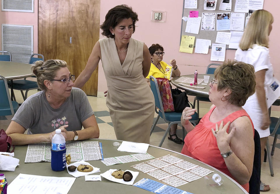 FILE- In this Aug. 2, 2018, file photo, Rhode Island Gov. Gina Raimondo, center, speaks with Lisa McGovern, left, and Betty Toye at the Pilgrim Senior Center in Warwick, R.I. Raimondo and U.S. Rep. Gwen Graham of Florida are among nine women running for governor who will face primary voters in coming weeks. No more than nine women have ever led states at the same time. (AP Photo/Michelle R. Smith, File)