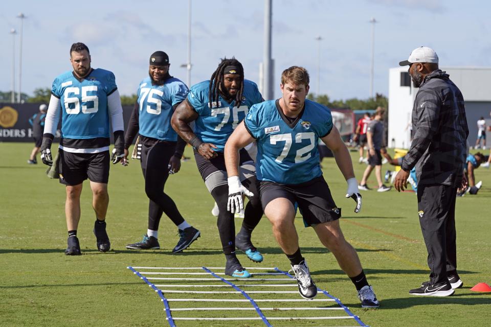 Jacksonville Jaguars offensive line members, from left, center Brandon Linder (65), offensive tackle Jawaan Taylor (75), offensive tackle Derwin Gray (70) and offensive tackle Walker Little (72) perform a drill during NFL football practice, Saturday, July 31, 2021, in Jacksonville, Fla. (AP Photo/John Raoux)