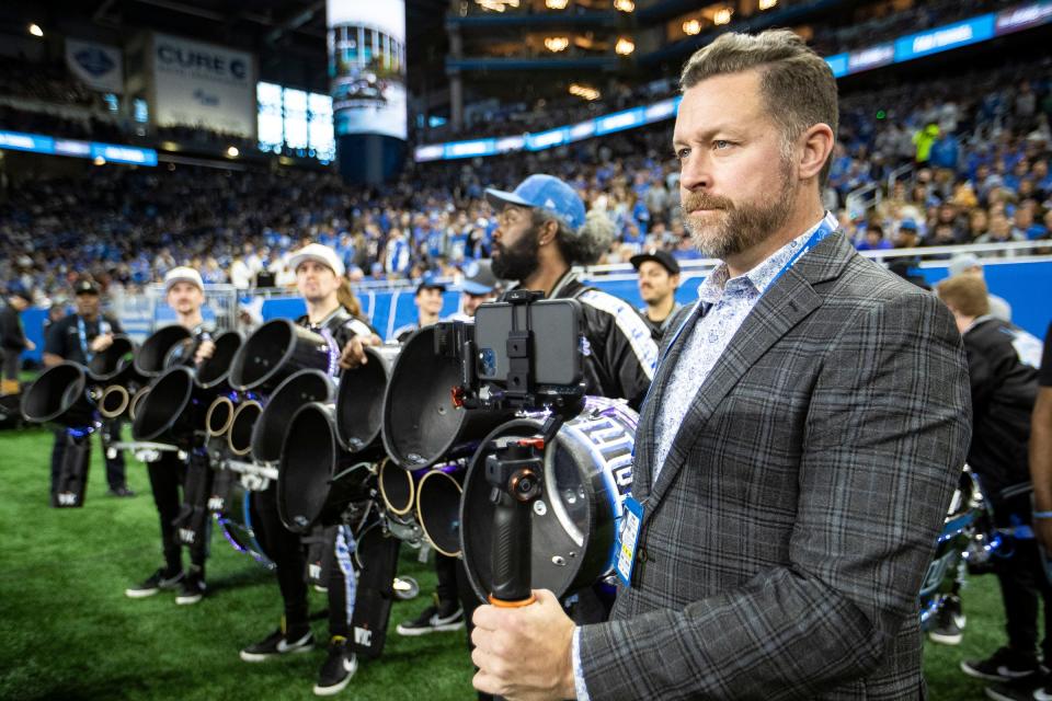 Detroit Lions drumline director Todd Ohme, right, gets ready to take the field for a performance at Ford Field in Detroit before the game against Chicago Bears on Sunday.