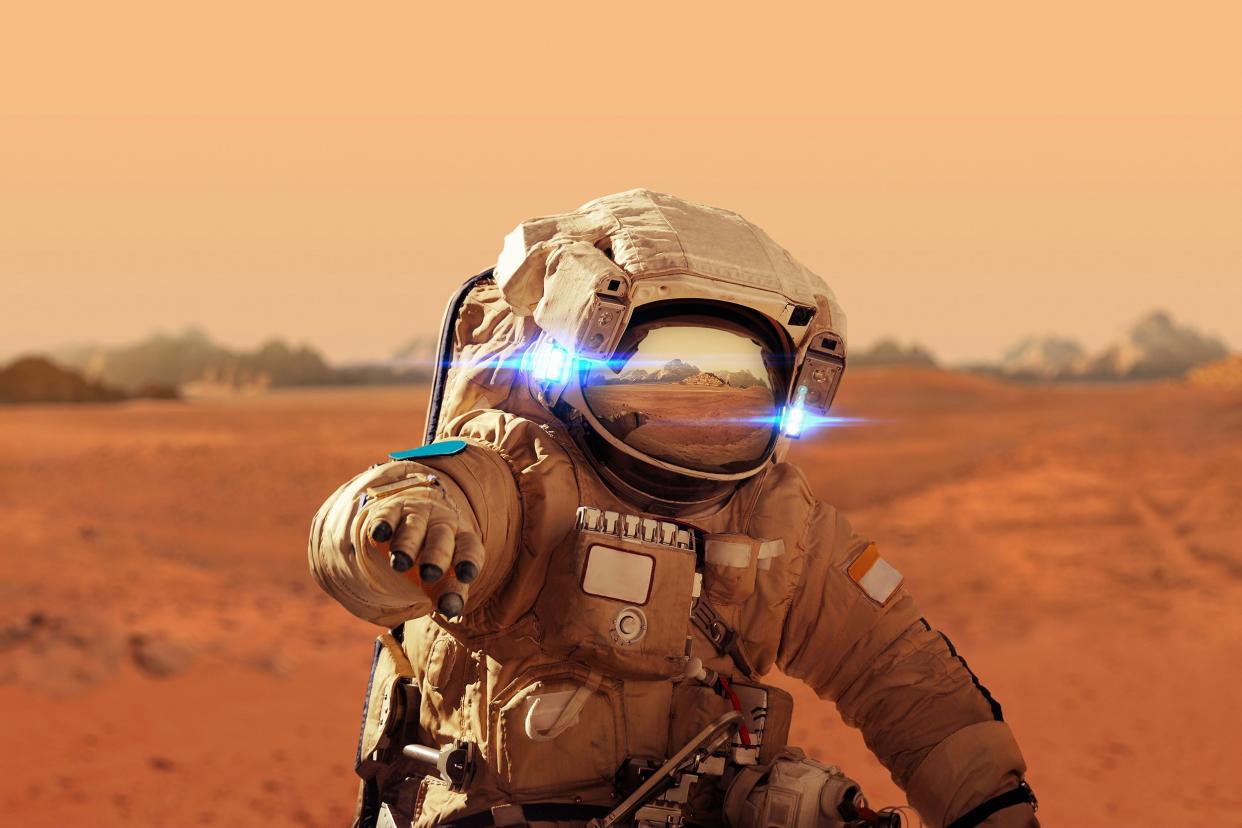 spaceman walks on the red planet Mars