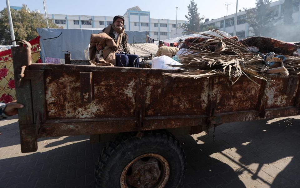 A man reacts as Palestinians, who fled their houses amid Israeli strikes, shelter at a United Nations-run school